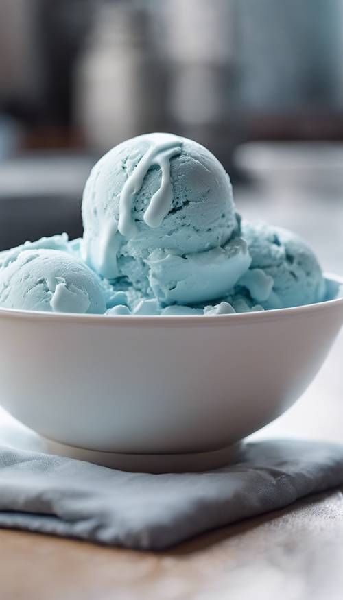 A fresh scoop of baby blue ice cream gently melting over a bright white bowl.