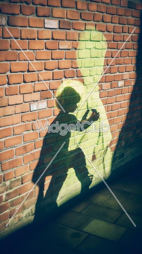 Kindersilhouette und grüner Schatten auf Ziegelmauer