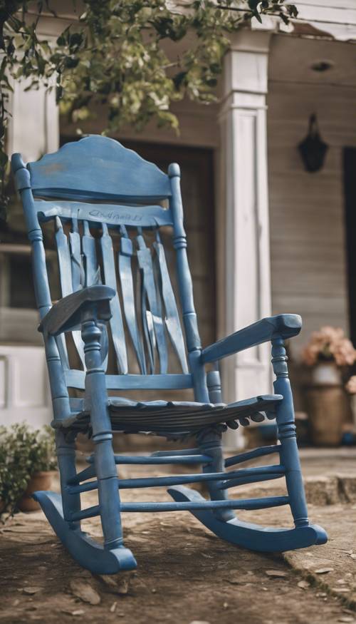 Cadeira de balanço de madeira azul feita à mão, sentada em uma varanda da frente.