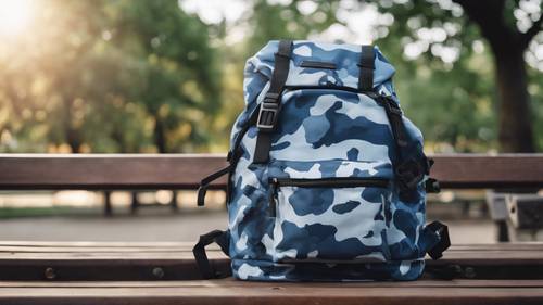 Blue camo backpack lying on a park bench.
