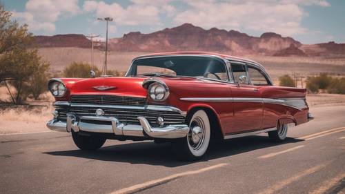 A classic red car with shiny black tires and chrome details on a Route 66 background