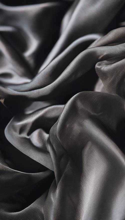 A close-up view of a perfectly woven piece of black silk draped elegantly.