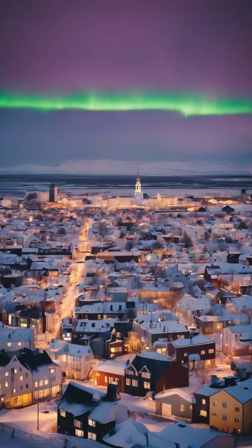 The snowy skyline of Reykjavik showing the northern lights dancing in the sky.