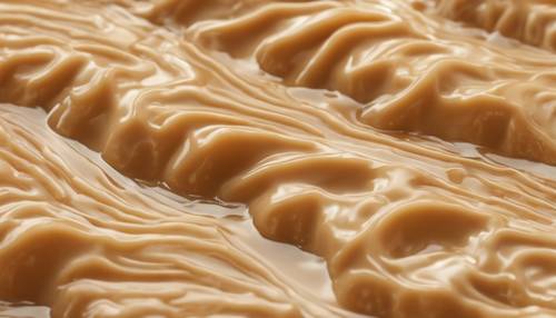 Uma textura de pudim de caramelo cremoso em cascata em padrões ondulados, com aparência deliciosamente atraente