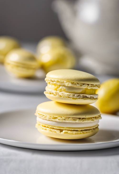 A pastel yellow macaron filled with lemon cream on a white ceramic plate.
