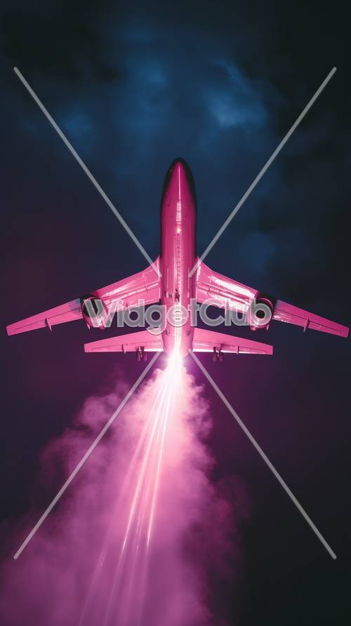 夜空を飛んでいるピンク色の飛行機