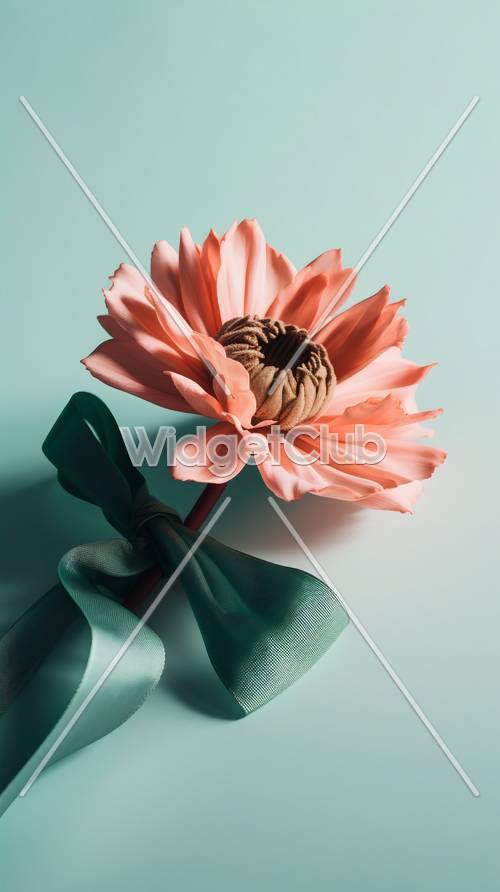Piękny różowy kwiat z zieloną wstążką