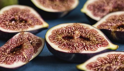 A macro shot of fig fruit cut in half, showing the intricate pattern inside.