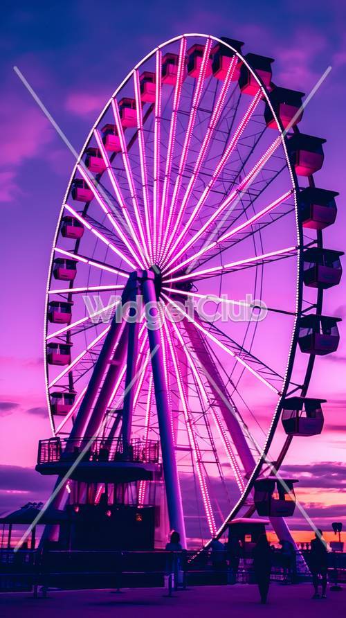 Розовое колесо обозрения под фиолетовым небом