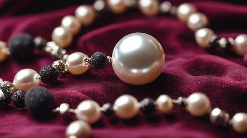 A pearl necklace sprinkled with black glitter, lying elegantly on a deep maroon velvet fabric.