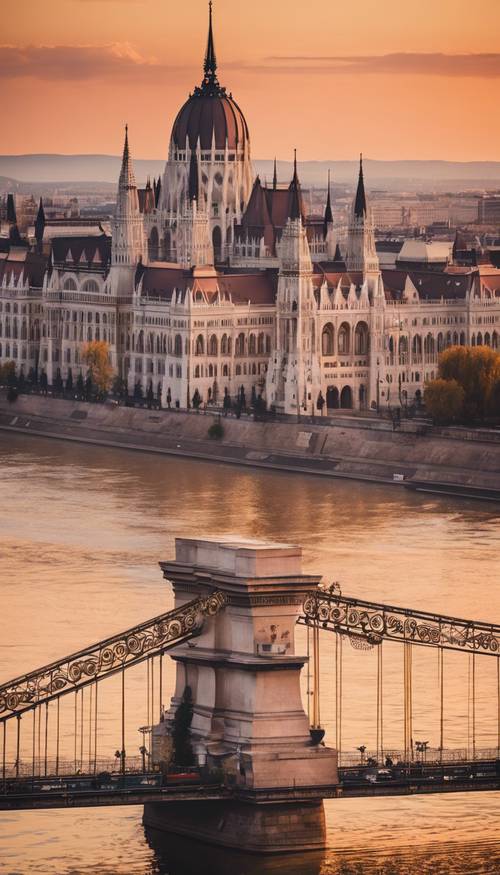 A sunrise view of Budapest with the Chain Bridge and the Hungarian Parliament Building in the distance.