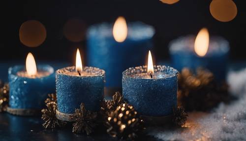 Blue Christmas candles softly glowing in a darkened room