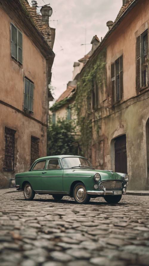 A vintage rusty green car parked on a cobblestone road. Tapet [0a4a2a91bd9a498ab8a6]