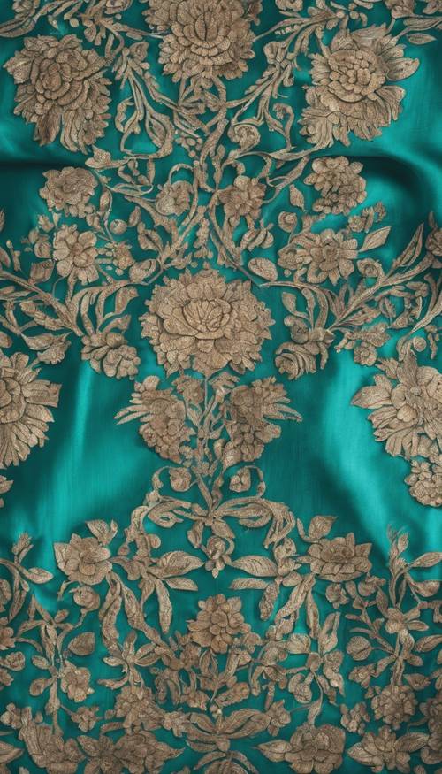 An ornate floral pattern on a teal colored silk saree