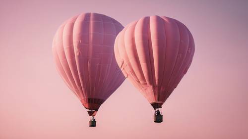 A light pink hot air balloon floating across a clear sky after sunrise.