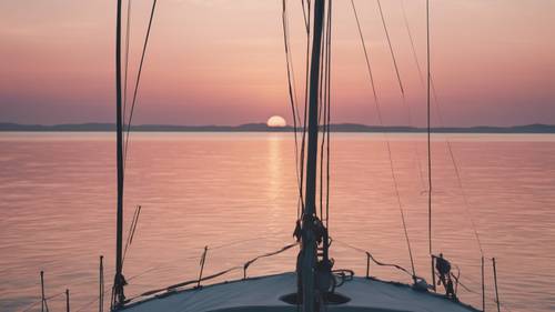 Pemandangan matahari terbit yang menenangkan dari dek perahu layar, dengan siluet pulau di kejauhan berlatar langit pagi bernuansa pastel.
