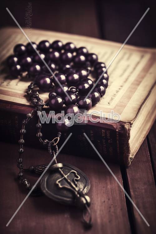 Dark Purple Rosary Beads on an Old Book