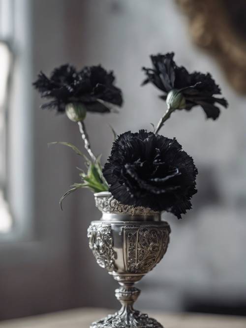 A Gothic still-life of a wilting black carnation in an ornate silver vase.