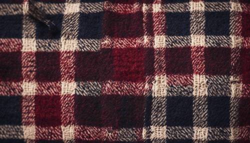 A woolen texture in a traditional Scottish plaid pattern with deep burgundy and navy hues.