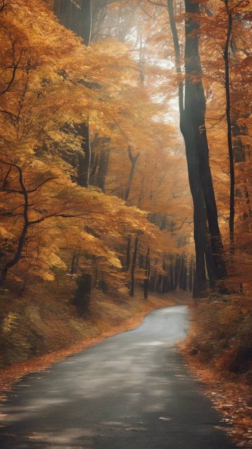 A winding road disappearing into a vibrant autumn forest.