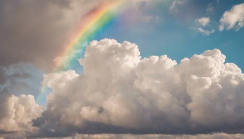 Um arco-íris se estendendo por um céu claro, com nuvens fofas ao fundo.
