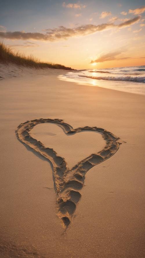 Un medio corazón dibujado en la arena de la playa durante un hermoso atardecer, con huellas de pies desnudos que conducen hasta él.