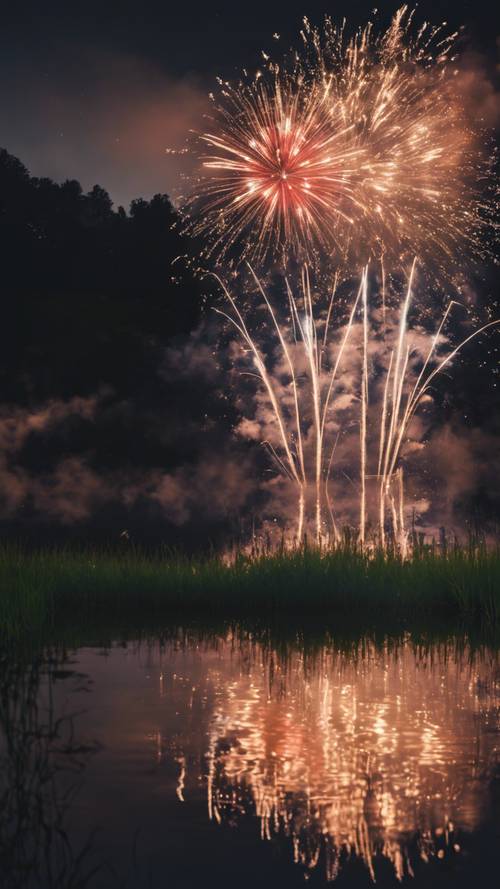 Fireworks reflected in the water of a lake on a tranquil Fourth of July evening.