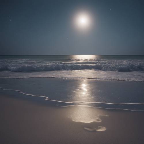 A silver aura radiating from a full moon lighting up a peaceful beach on a clear night.