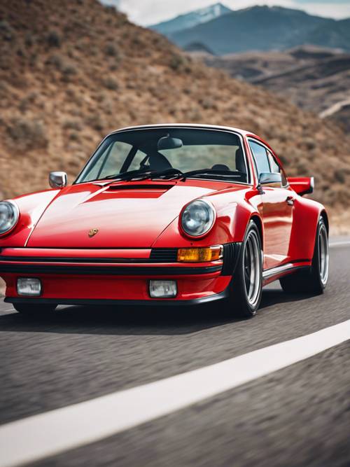 一辆经典的赛车红色保时捷 911 Turbo，沿着开阔的高速公路飞驰，远处是群山。