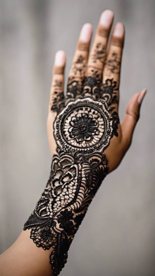 An intricate Indian henna design featuring blooming black flowers on the wrist.