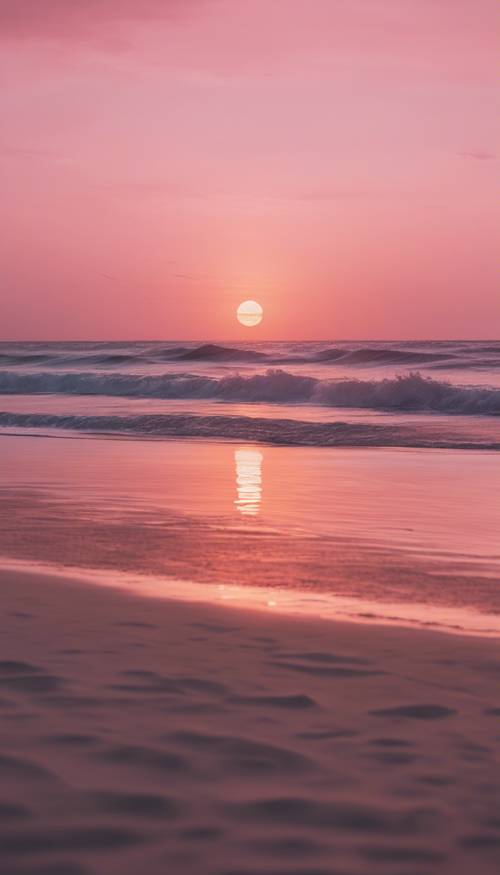 Pemandangan pantai yang tenang saat matahari terbenam dengan aura merah jambu dan jingga yang halus menyinari perairan laut yang tenang.