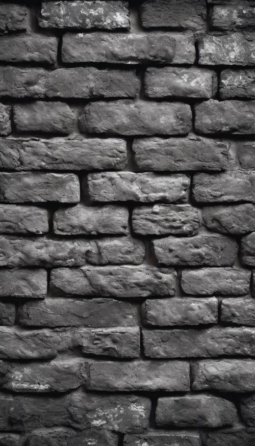 Uma parede de tijolos cinza escuro, exibindo a textura e aspereza da velhice.