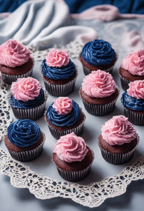 Decadent navy blue velvet cupcakes with fluffy pink frosting on a white lace tablecloth.