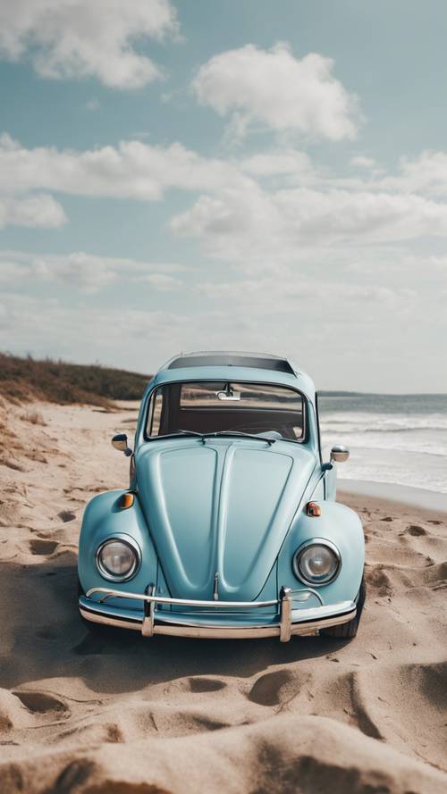 A vintage pastel blue Volkswagen beetle parked near a beach.