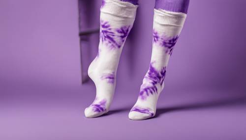 A pair of white cotton socks adorned with a purple tie-dye pattern.