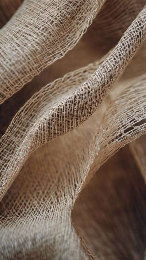 Tampilan jarak dekat abstrak dari serat linen tenun dengan fokus lembut.