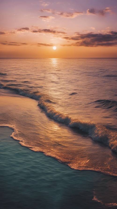 Matahari terbit yang menakjubkan di atas lautan, mencerminkan warna-warna cerah di laut pagi yang tenang.