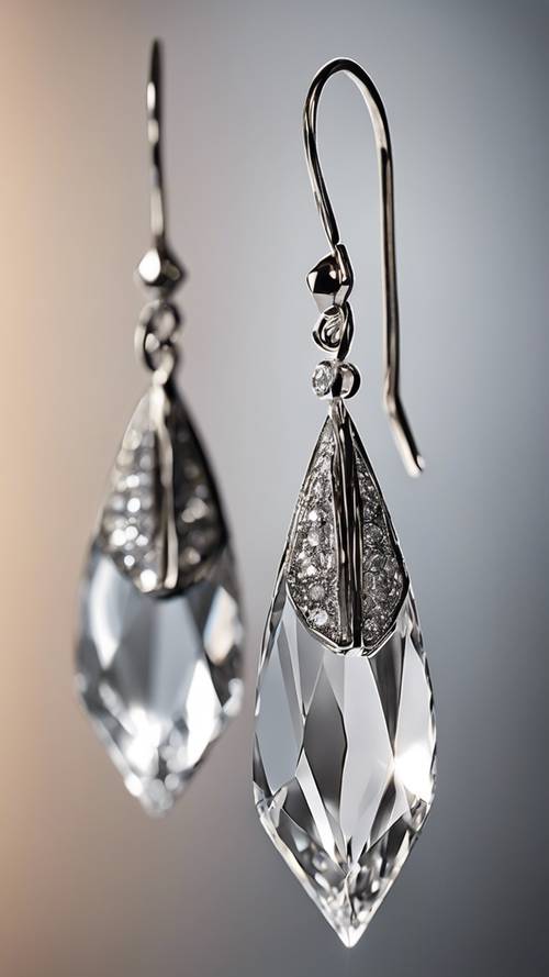 Gray diamond teardrop earrings hanging gracefully.