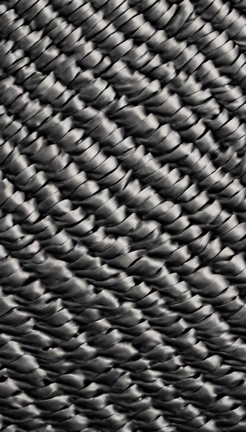 Dark carbon fiber offered in a weave pattern, conveying the strength and resilience of the material