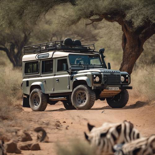 A rugged Land Rover Defender on a thrilling safari adventure amidst wild animals in Africa. Tapet [3a1cb64119f64351bc18]