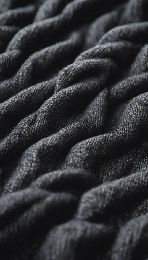 Un motif détaillé d’un tissu de laine épais et noir.