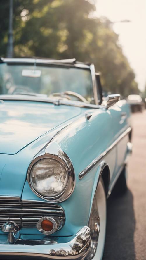 A vintage convertible car painted in preppy pastel blue.
