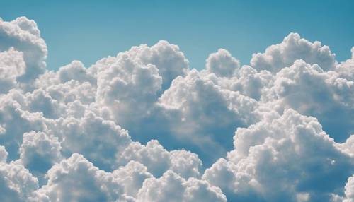 Soft fluffy clouds against a clear blue sky in a seamless pattern.