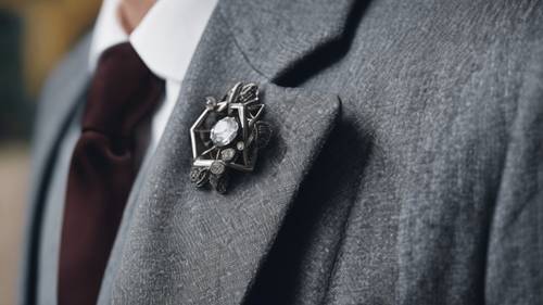 Một chiếc trâm cài kim cương màu xám trang nhã được ghim trên ve áo của một quý ông.