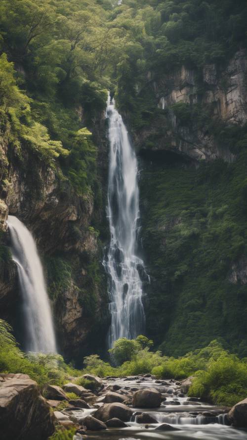 A grand waterfall cascading over rugged cliffs, surrounded by lush greenery.