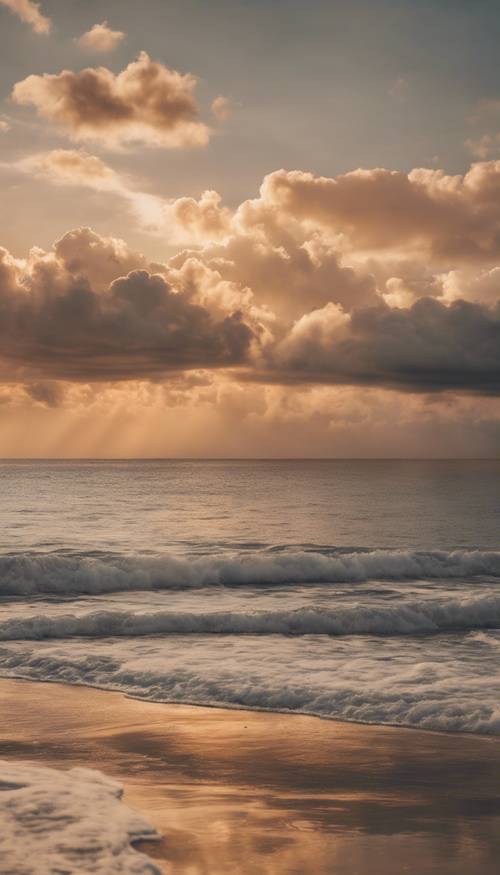 Ciepłe, beżowe chmury unoszące się nad spokojnym morzem o świcie.