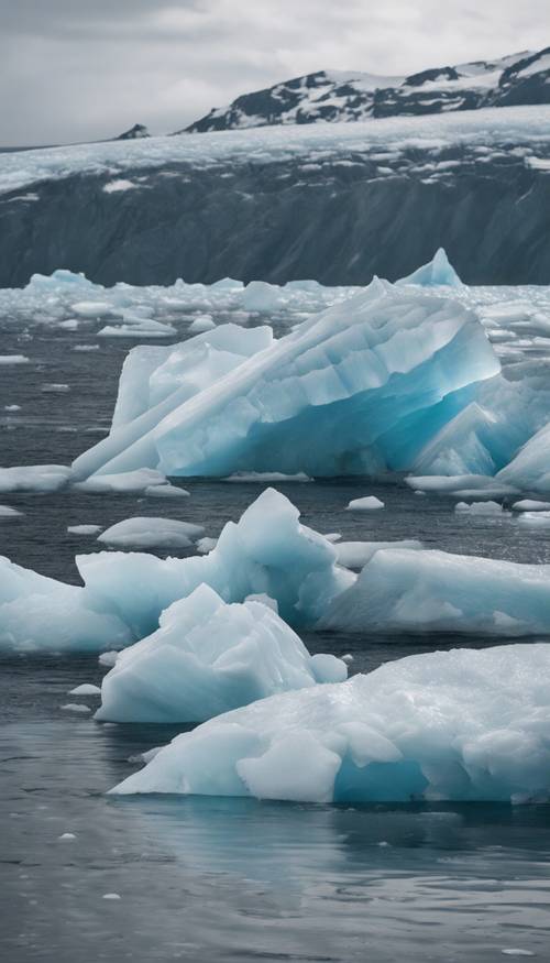 A glacier in the process of calving, with chunks of ice falling into the sea