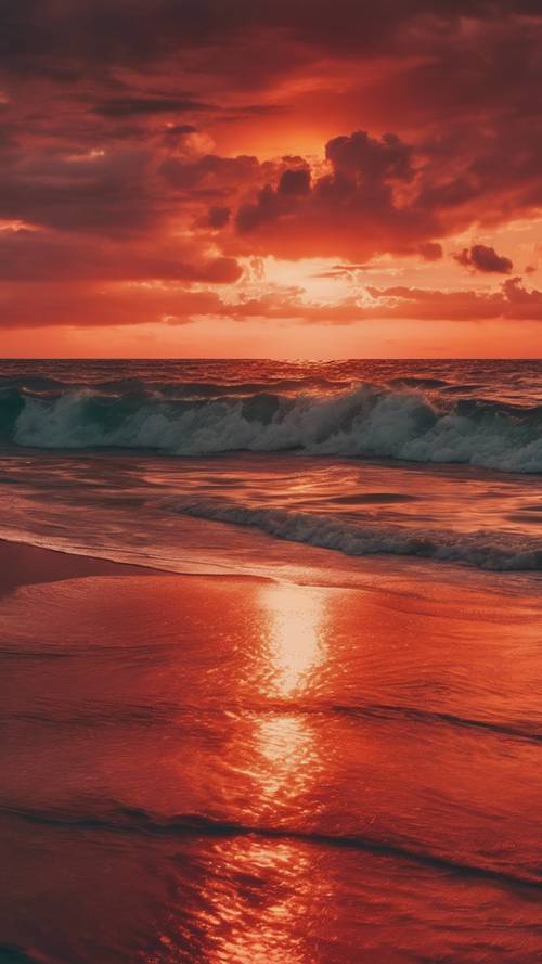 穏やかな海に広がる鮮やかな赤とオレンジ色の夕焼け