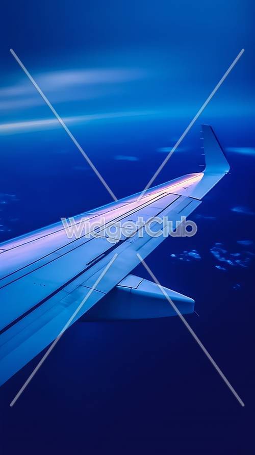 High Above the Clouds – Soaring Airplane Wing View