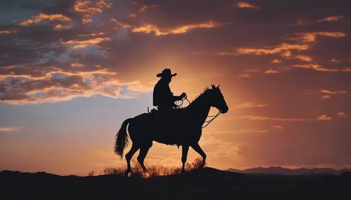 คาวบอยผู้โดดเดี่ยวขี่ม้าคู่ใจของเขา โดยมีเงาตัดกับพระอาทิตย์ตกที่ร้อนแรงทางทิศตะวันตก